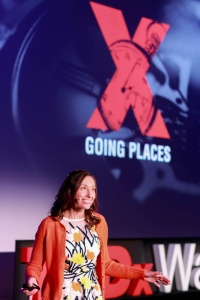TEDx speaker in orange cardigan