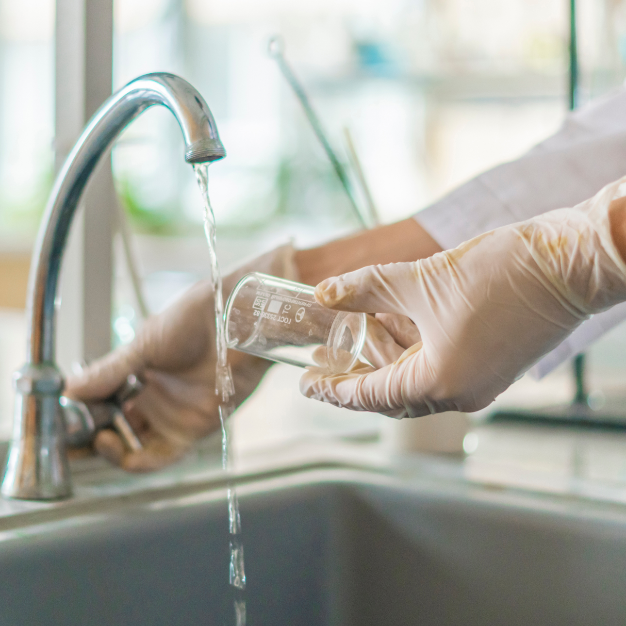beaker being rinses in sink